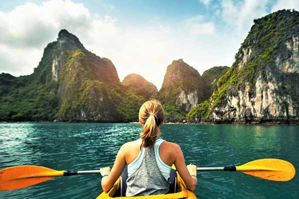 Kayaking amidst the limestone formations of Ha Long Bay, Vietnam during the dry season.