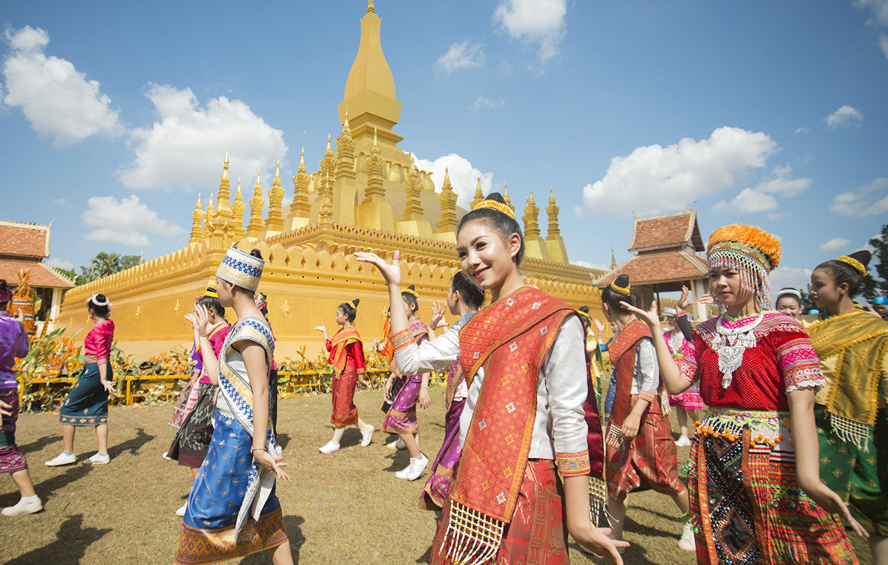 Crowd of people, gathered around Pha That Luang during a festival, Vientiane, Laos.